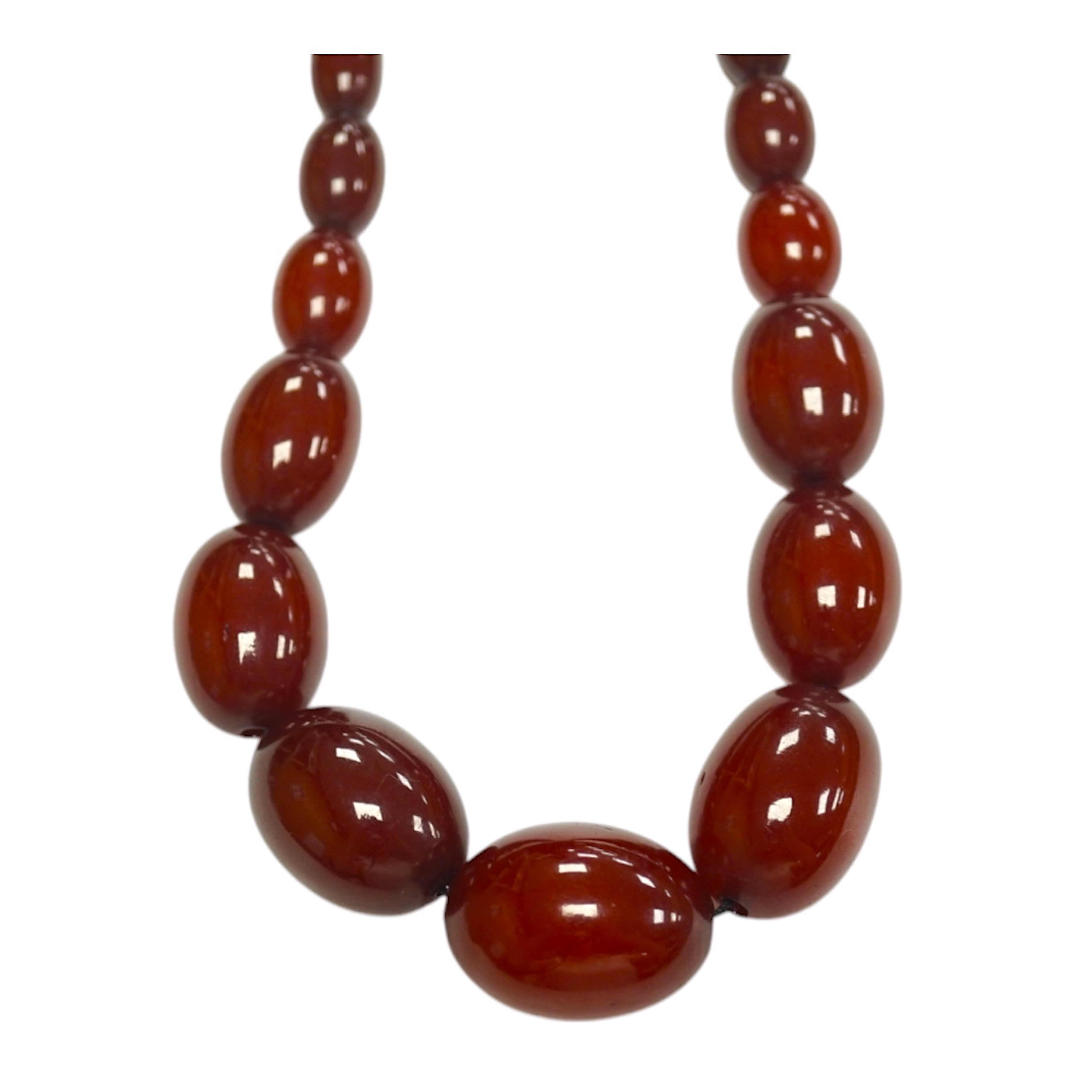 A single strand graduated oval simulated cherry amber bead necklace, 74cm, gross weight 71 grams. Condition - fair